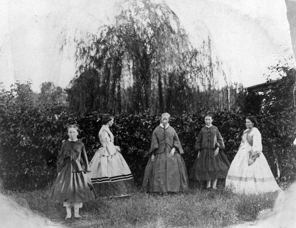 Group of women and girls in the garden, 1860-1870