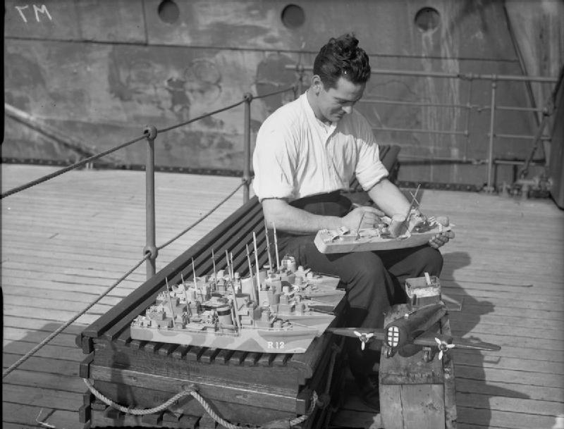 Petty Officer H Bell, of Shotts, Lanarkshire, a member of the Home Fleet, constructs model ships and aircraft to be given as presents for Christmas