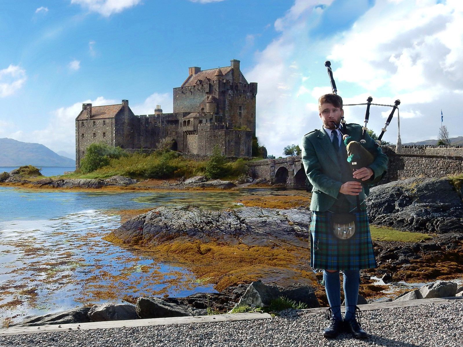Piper in front of Eilean Donan Castle. Credit Marshalhenrie