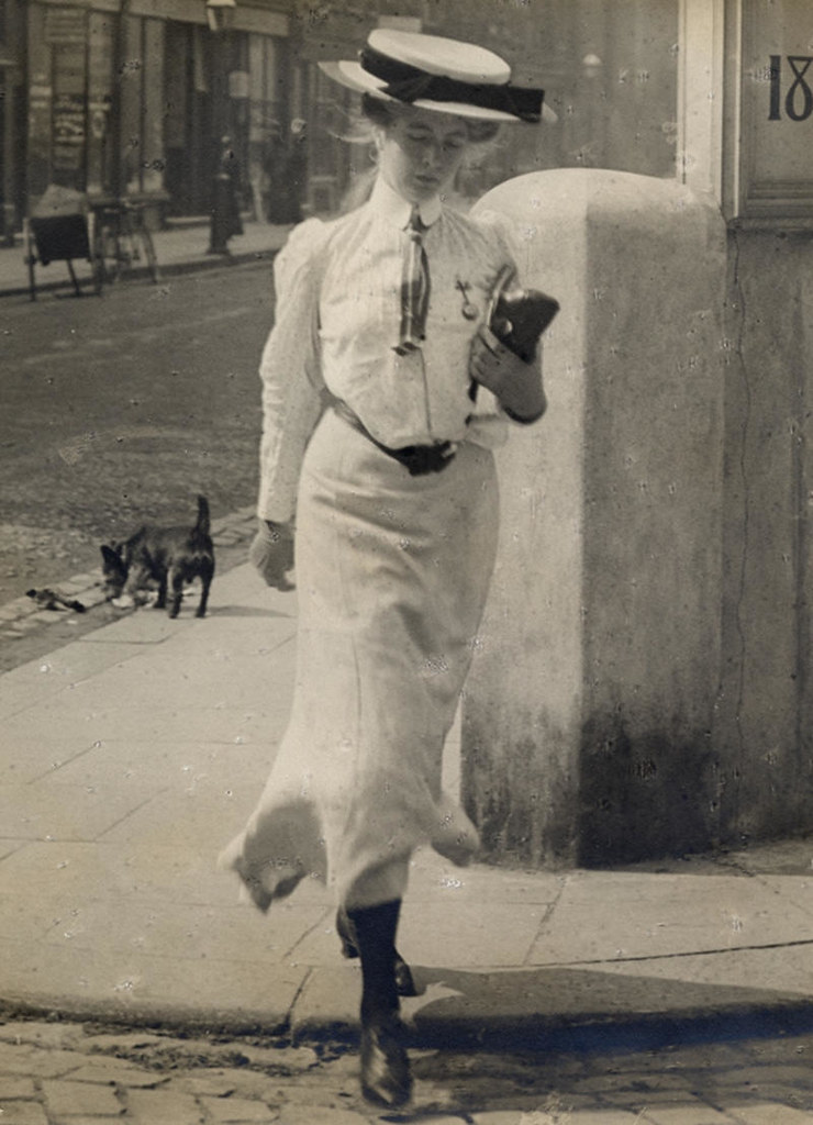 A young woman carrying something. Can't be an iPhone, can it