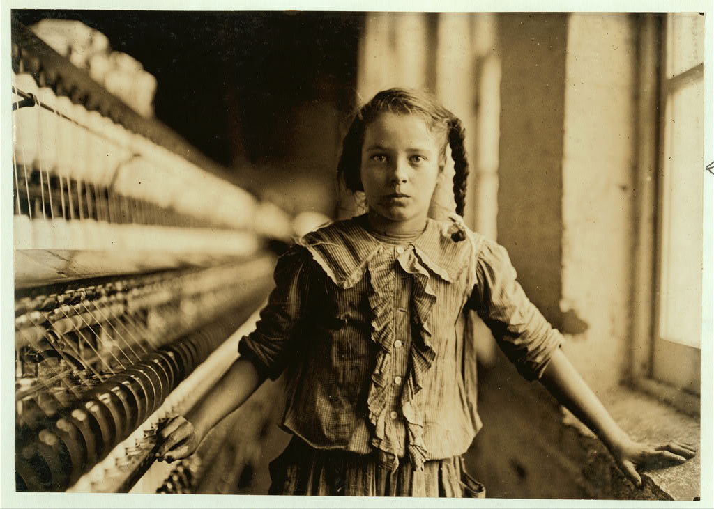 One of the spinners in Whitnel Cotton Mfg. Co. N.C. She was 51 inches high. Had been in mill 1 year. Some at night. Runs 4 sides, 48 cents a day. When asked how old, she hesitated, then said "I don't remember." Then confidentially, "I'm not old enough to work, but I do just the same." Out of 50 employees, ten children about her size.