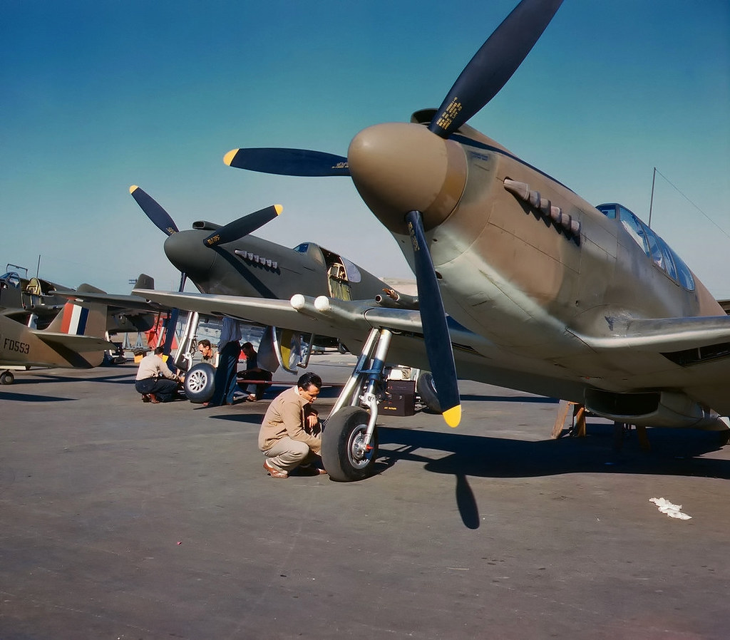 North American NA-91 Mustang fighters being serviced at North American Aviation at Inglewood, California (USA), in October 1942. After passing of the lend-lease act in March 1941, the USAAF ordered 150 NA-93 Mustang Mk IA fighters on 25 September 1941 for delivery to the United Kingdom. The RAF serial numbers assigned were FD418-FD567 (FD553 is visible on the left). For contractual purposes, these aircraft were assigned the U.S. designation of P-51 (USAAF serials 41-37320 to 41-37469). The Mustang IA differed from earlier versions in having the machine guns replaced by four 20 mm wing-mounted Hispano cannon. After December 1941 serials FD418-FD437, FD450-FD464, FD466-FD469, and FD510-FD527 were reposessed by the USAAF (and briefly named A-36A Apache). Original caption: "P-51 fighter planes being prepared for test flight at the field of the North American Aviation, Inc., plant in Inglewood, Calif.