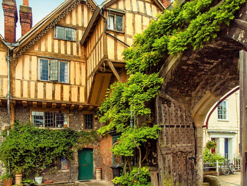 The 15th century Cheyney Court and Priory Gate in the Close of Winchester Cathedral. Credit Anguskirk, flickr