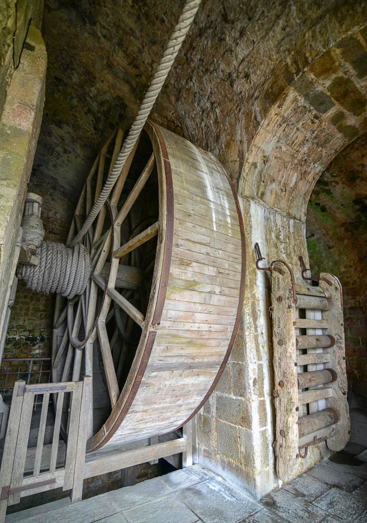 Treadwheel crane served as a windlass, installed when Mont Saint-Michel was a prison, to bring supplies prisoners. Some prisoners would walk inside the wheel to rotate it. Credit Jorge Láscar