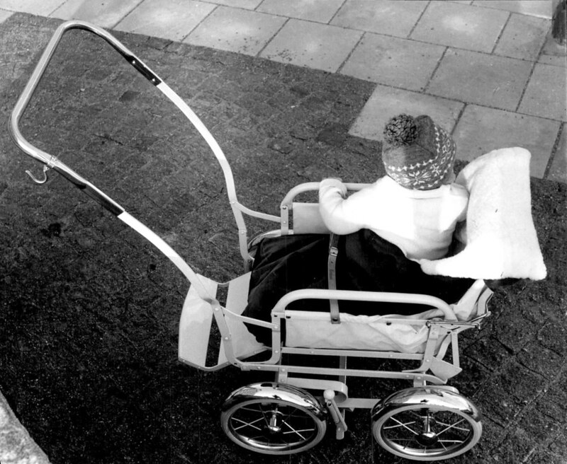 A toddler in a lightweight sports pram, 1959