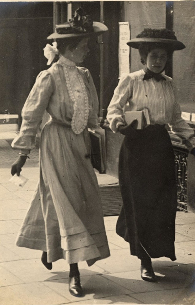Two women talking carrying books, 1908