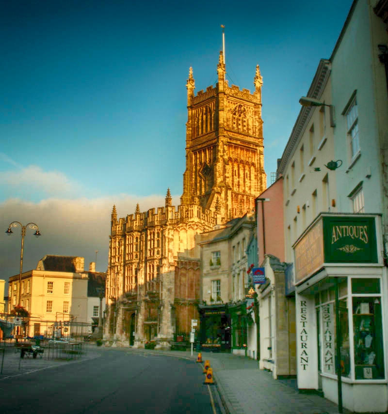 Street in Cirencester with St John the Baptist parish church. Credit SLR Jester