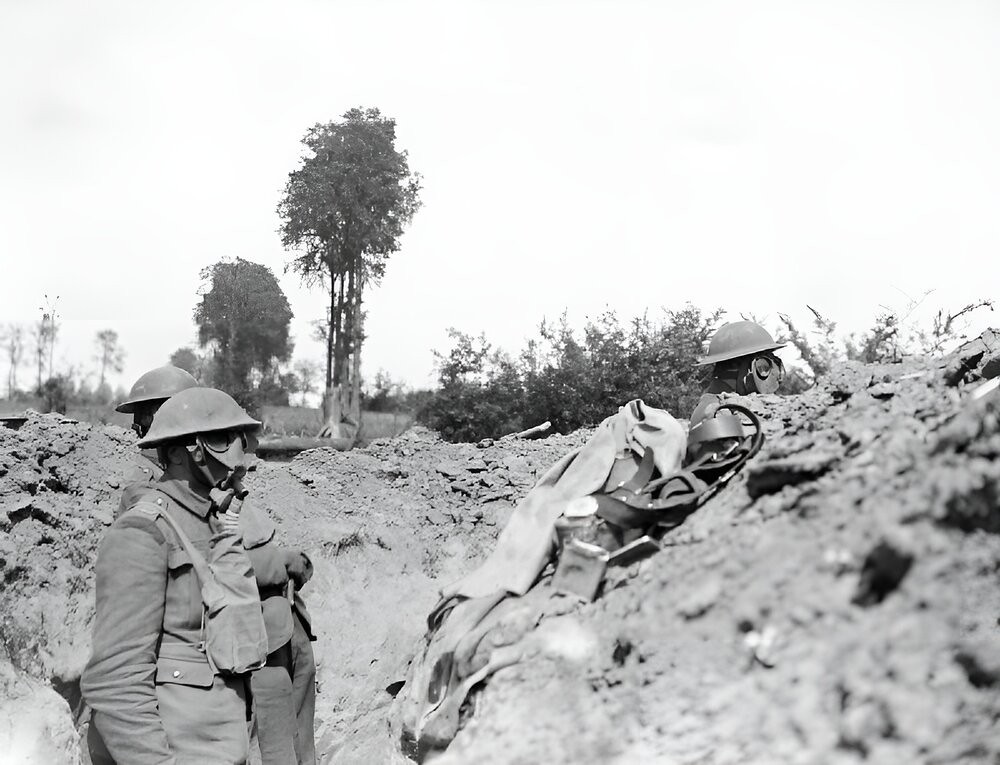Men of the 12th Royal Scots wear respirators during a gas attack on a front line trench, Meteren.