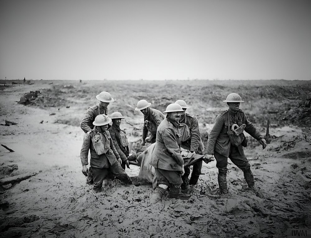 Stretcher bearers struggle in mud up to their knees to carry a wounded man to safety near Boesinghe on 1 August 1917 during the Third Battle of Ypres.