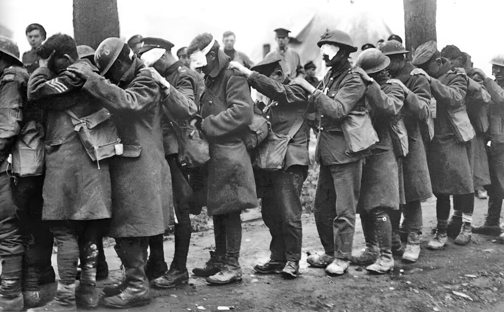 British 55th (West Lancashire) Division troops blinded by tear gas await treatment 10 April 1918, part of the German offensive in Flanders.